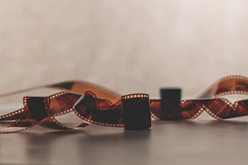 retro filmstrip, brown film, softly focused, blurred background, evoking nostalgia, vintage film, film reel, nostalgic image, classic film, film photography, analog film