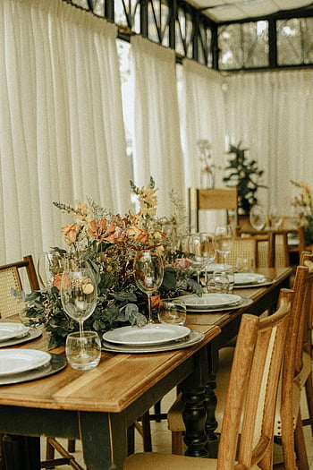 elegáns rusztikus étkező, táblázat beállítása, virágos elrendezések, elegáns üvegáru, tányérok, bájos rusztikus asztal, étkezőasztal, rusztikus dekorációval, elegáns étkészlet, rusztikus virágok, rusztikus étkező