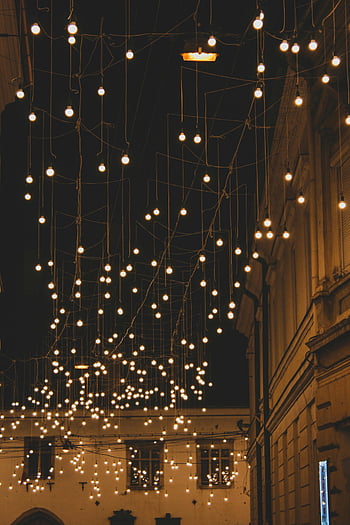 string lights, brown concrete building, night time, decorative lights, Cluj-Napoca, Romania, evening scene, street lights, urban night scene, hanging lights, charm