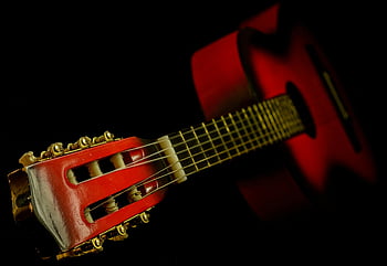red classical guitar, close-up, strings, fretboard, dark background, acoustic guitar, musical instrument, guitar details, guitar headstock, guitar body, guitar strings