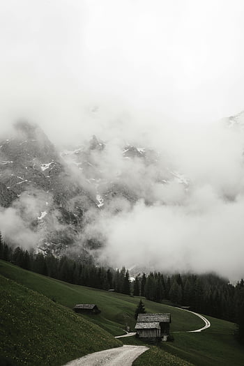 cloudy day, countryside, peaceful rural scene, cabin, foggy mountains, lush greenery, winding road, mountain views, rural landscape, serene nature, misty hills