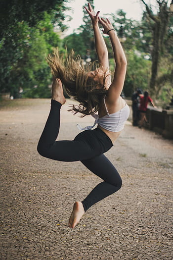 ballerina dancing, elegant dance leap, outdoor performance, movement, grace, woman dancing, outdoor dance, dance photography, ballet leap, artistic movement, nature backdrop