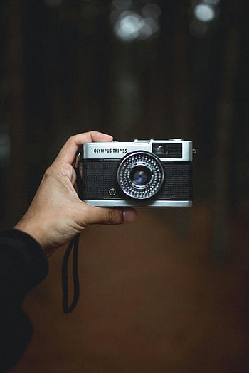 Olympus Trip 35, classic camera, gray and black, handheld camera, blurred background, natural background, vintage camera, photography, analog camera, compact camera, film camera