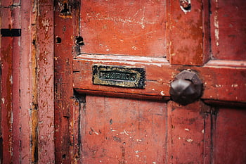 red wooden door, weathered door, vintage letterbox, peeling paint, close-up photo, wooden door texture, old door, rustic door, letterbox slot, door knob, aged wood