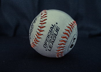 official league baseball, white and orange baseball, close-up baseball, detailed baseball, black textile background, baseball branding, baseball stitches, sports equipment, baseball ball, league baseball, sports ball