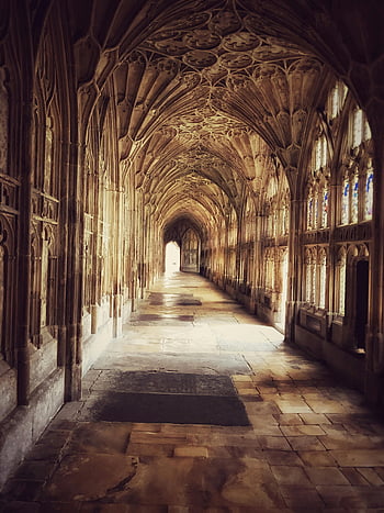 Gothic architecture, Gloucester Cathedral, historic cloister, England, detailed architecture, stone hallway, medieval design, religious building, architectural details, stone arches, stained glass windows