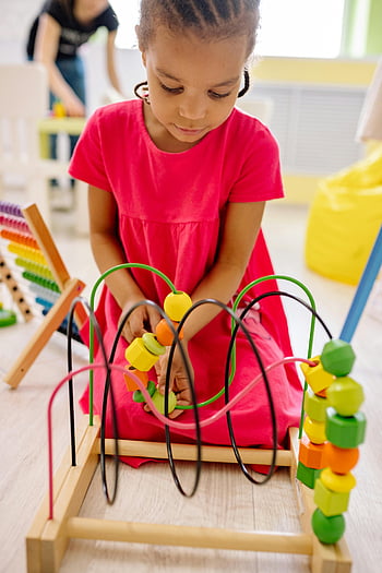 girl-in-pink-dress-playing-with-abacus-colorful-educational-toys-vibrant-classroom-setting-young-girl-educational-activities-classroom-environment-learning-toys-early-childhood-thumbnail.jpg