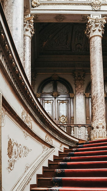 Dolmabahçe Palace, Istanbul, stairway, intricate architecture, opulent design, marble columns, red carpet, ornate details, historical palace, Turkish heritage, grand staircase