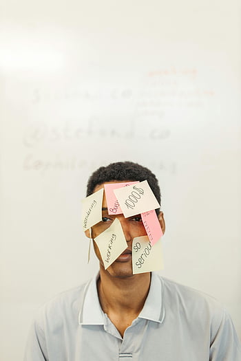 sticky notes, man's face, portrait, conceptual theme, various sticky notes, face covered, white background, colorful notes, written notes, artistic expression, unique photography