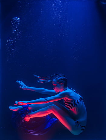 woman swimming underwater, underwater photography, vibrant underwater pose, colorful lights, artistic underwater pose, underwater woman, underwater scene, underwater art, underwater lighting, underwater model, underwater fashion