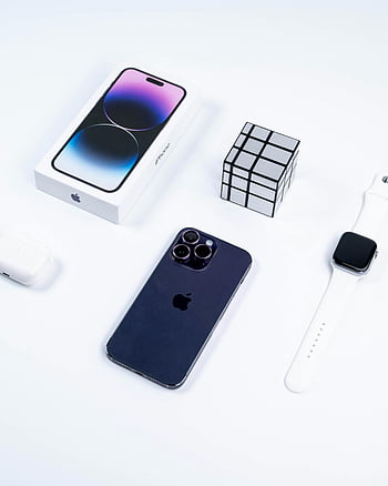 Apple iPhone, smartwatch, accessories, minimalist layout, studio setup, Apple products, Rubik's cube, tech gadgets, white background, Apple watch, AirPods case
