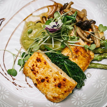 tofu, asparagus, mushrooms, edible flower, plated food, gourmet dish, vegetarian meal, fine dining, healthy eating, culinary art, plate presentation