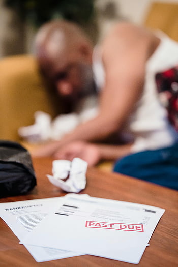 unpaid bills, table, distraught man, background, depressed man, overdue bill notices, financial stress, bankruptcy, past due, crumpled papers, financial crisis