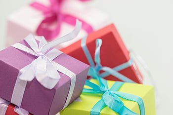 gift boxes, selective focus, vibrant colors, festive occasions, close-up photography, ribbons, wrapped presents, holiday gifts, colorful packaging, gift wrapping, celebration items