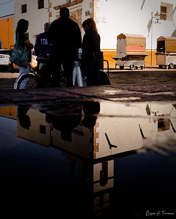 street photography, reflections, everyday moments, urban life, candid shot, street scene, shadows and light, depth in frame, visual storytelling, street vibes, moody tones