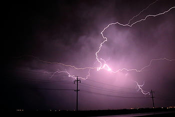 lightning strike, nighttime, stormy night sky, silhouetted power lines, stunning lightning bolts, night photography, thunderstorm, electrical storm, natural phenomenon, night thunderstorm, power line silhouette