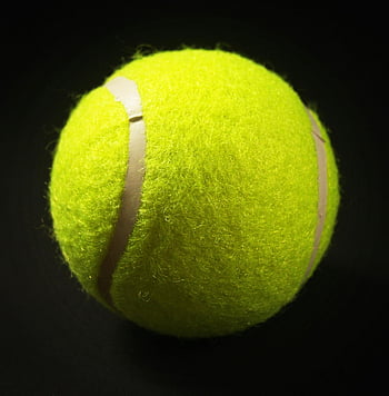 floating tennis ball, yellow tennis ball, black background, vivid close-up, tennis ball, sports equipment, high contrast, isolated object, bright yellow, sports ball, close-up image