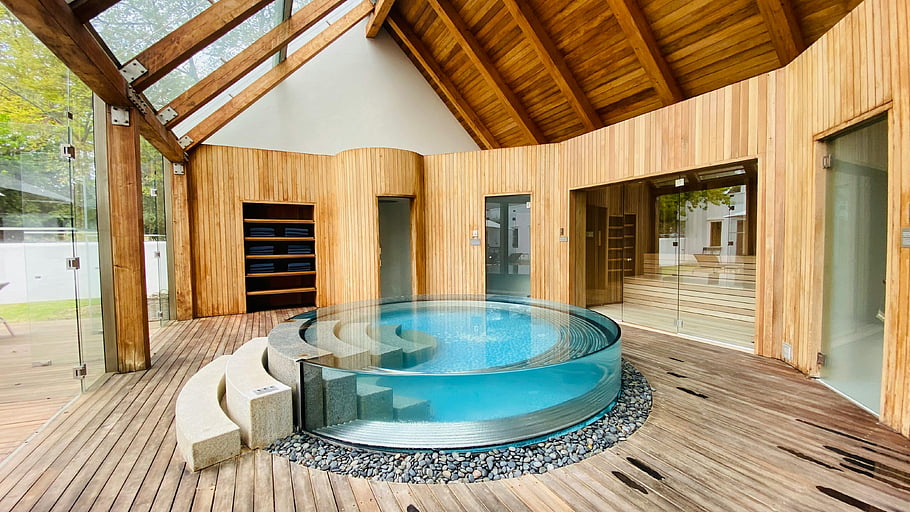 modern wooden interior, jacuzzi, indoor spa, wooden architecture, glass features, circular jacuzzi, tranquility, modern spa, wooden design, indoor pool, spa relaxation