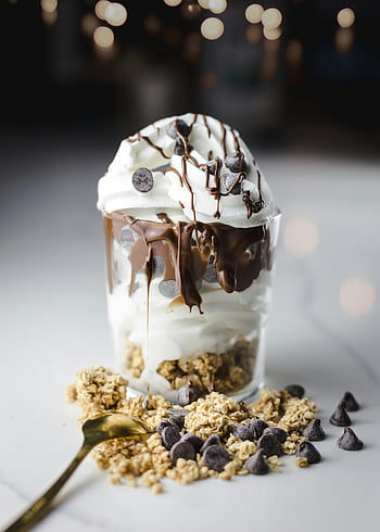 chocolate yogurt, parfait, dessert, chocolate chips, yogurt, drizzle sauce, close-up shot, glass, granola, whipped cream, chocolate drizzle