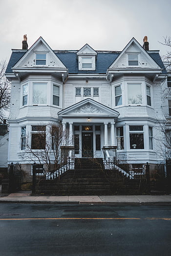 Victorian-style house, white exterior, symmetrical architecture, classic residential, staircase, pediment, grand facade, white house, architectural details, Victorian home, residential building