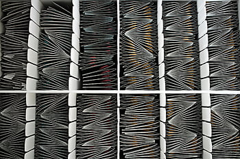 paper document organization, top view of folded papers, container with separators, organized documents, neatly organized documents, document separators, paper filing system, document storage, documents in a container.