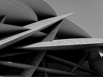 modern architecture, sharp angles, Doha Qatar, dynamic design, geometric patterns, contemporary building, abstract shapes, urban landscape, architectural details, black and white, modern building walls