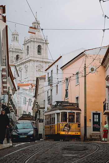 Lisbon, Tram 28, Monastery of Sao Vicente de Fora, historic streets, Portugal, iconic tram, Sao Vicente de Fora, Lisbon tram, historic architecture, European cityscape, cobblestone streets