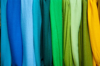 Colorful fabrics, spectrum order, vibrant display, fabric display, color gradient, fabric gradient, colors from blue to yellow, fashion textiles, texture design.
