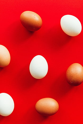 eggs, red background, white eggs, brown eggs, vibrant red, Easter themes, top view, arranged eggs, festive eggs, colorful eggs, minimalistic design
