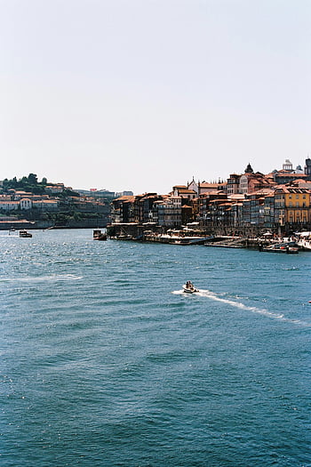 Porto waterfront, traditional architecture, serene water, Portugal, picturesque view, Douro River, historic buildings, coastal city, European charm, travel destination, cityscape