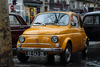 yellow car, Fiat 500, classic car, urban street, retro style, parked car, bustling street, vintage car, yellow Fiat, city scene, EE-543-ZE