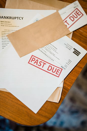past due, bankruptcy papers, wooden table, financial documents, overdue bills, debt notices, financial stress, financial crisis, payment overdue, financial paperwork, financial trouble