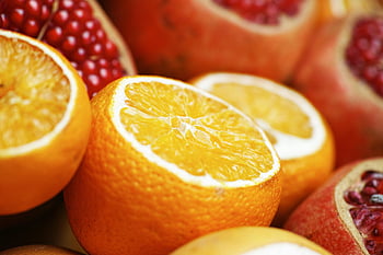 sliced oranges, pomegranates, vibrant freshness, healthy breakfast, close-up photo, juicy fruits, orange slices, pomegranate seeds, fruit close-up, breakfast fruits, orange pomegranate