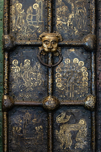Black and Gold Old Steel Gate, Detailed metal door, religious artwork, vintage door knocker, antique gate, ornate metalwork, historical door, religious scenes, vintage knocker, decorative metal door, black and gold gate