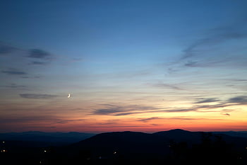 silhouette of mountains, golden hour photography, peaceful twilight, crescent moon, distant hills, skyscape, sunset, evening landscape, natural scenery, serene view, twilight sky