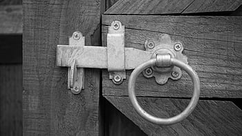 grayscale photo, door knock, rustic wooden gate, metal latch, ring handle, vintage elements, security elements, close-up shot, black and white, antique hardware, outdoor gate