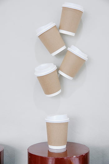disposable cups, take away beverages, minimalist installation, brown paper coffee cups, floating cups, minimalist style, white wall, paper cups, coffee cups, minimalist design, floating objects