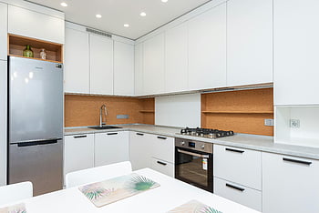 modern kitchen, white cabinets, minimalist decor, sleek design, kitchen appliances, stainless steel fridge, contemporary kitchen, open shelving, gas stove, kitchen island, clean lines