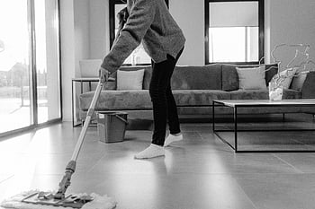 grayscale photo, person mopping, modern living room, floor cleaning, home cleaning, mopping floor, black and white, indoor cleaning, domestic chores, tiled floor, living room decor