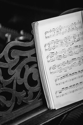 piano, bladmuziek, sierlijke piano, klassieke setting, muzieknoten, detailopname, zwart en wit, muzikale compositie, piano toetsen, vintage piano, muziekboek