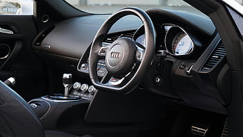 Audi R8, black Audi steering wheel, sleek interior design, sports car dashboard, Audi interior, luxury car interior, car steering wheel, dashboard design, Audi R8 interior, car interior design, sports car steering wheel