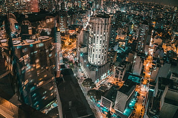aerial photography, city at night, illuminated skyscrapers, vibrant lights, nighttime cityscape, urban skyline, aerial view, bustling city, city lights, night photography