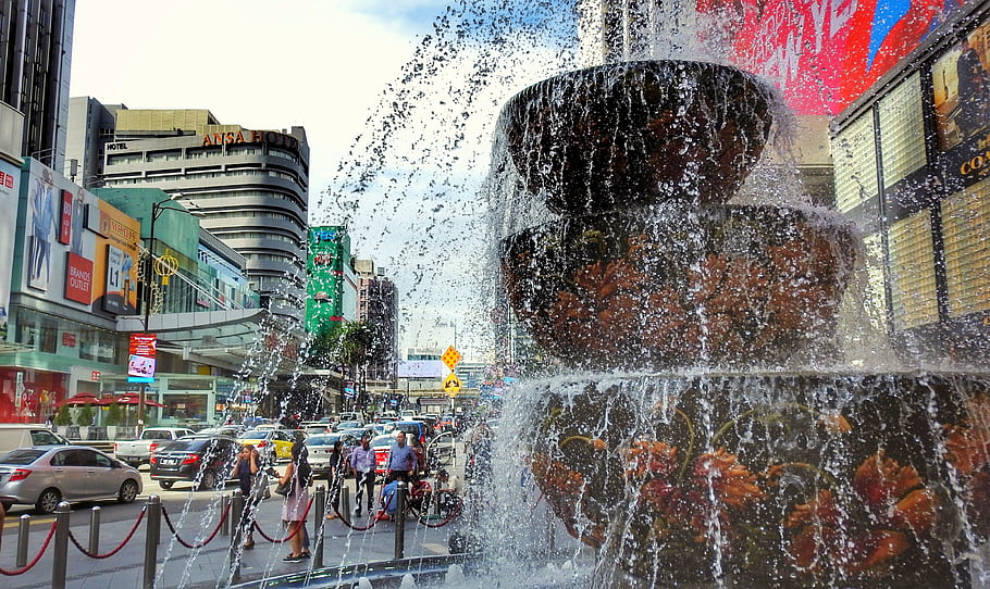 fountain, shopping, Kuala Lumpur, Malaysia, cityscape, street, pedestrians, cars, buildings, advertisements, water