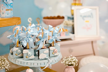 baby shower, dessert table, pastel decorations, sweet treats, blue figurines, elegant setup, baby shower decorations, pastel colors, dessert display, baby shower treats, blue ribbons