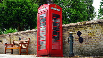 red telephone booth, British culture, vintage phone booth, brick wall, outdoor scene, classic telephone box, red phone box, British icon, public phone booth, traditional phone booth, red booth