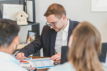 real estate agent, mortgage options, clients, office setting, financial discussion, real estate, mortgage, office meeting, professional consultation, real estate consultation, financial planning