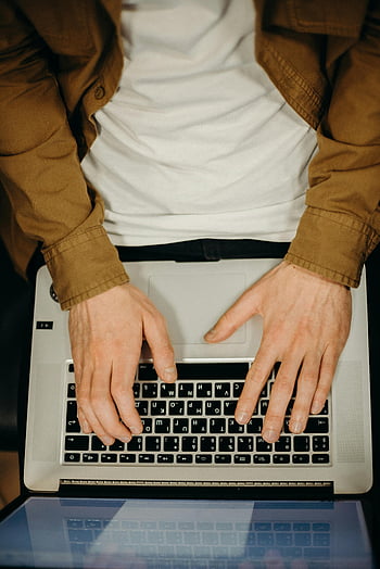 person typing, gray laptop, top view, hands typing, laptop keyboard, remote work, technology, work from home, digital work, professional typing, office work