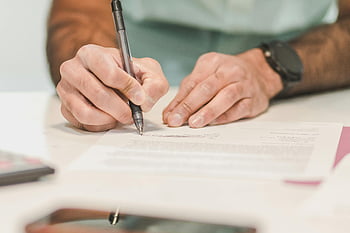 man signing, official document, ballpoint pen, close-up, desk, white paper, writing, hands, watch, formal, paperwork