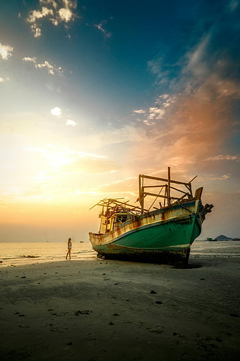 abandoned fishing boat, sunset, Thai beach, tranquil beauty, wanderlust, seashore, woman standing, white and green ship, beach scene, travel photography, serene landscape