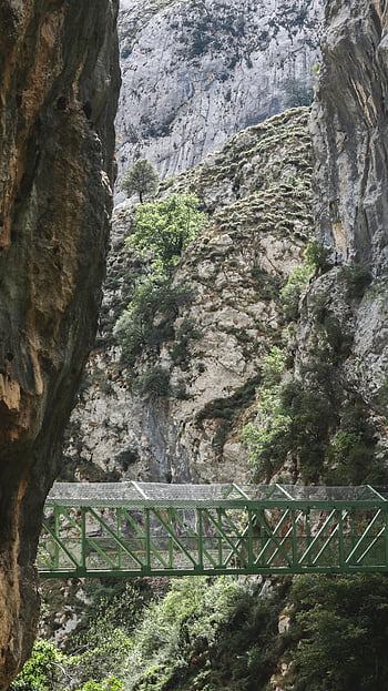 green metal bridge, rocky mountain, Picos de Europa, Spain, majestic view, rocky cliffs, green bridge, natural landscape, mountain scenery, outdoor photography, travel destination